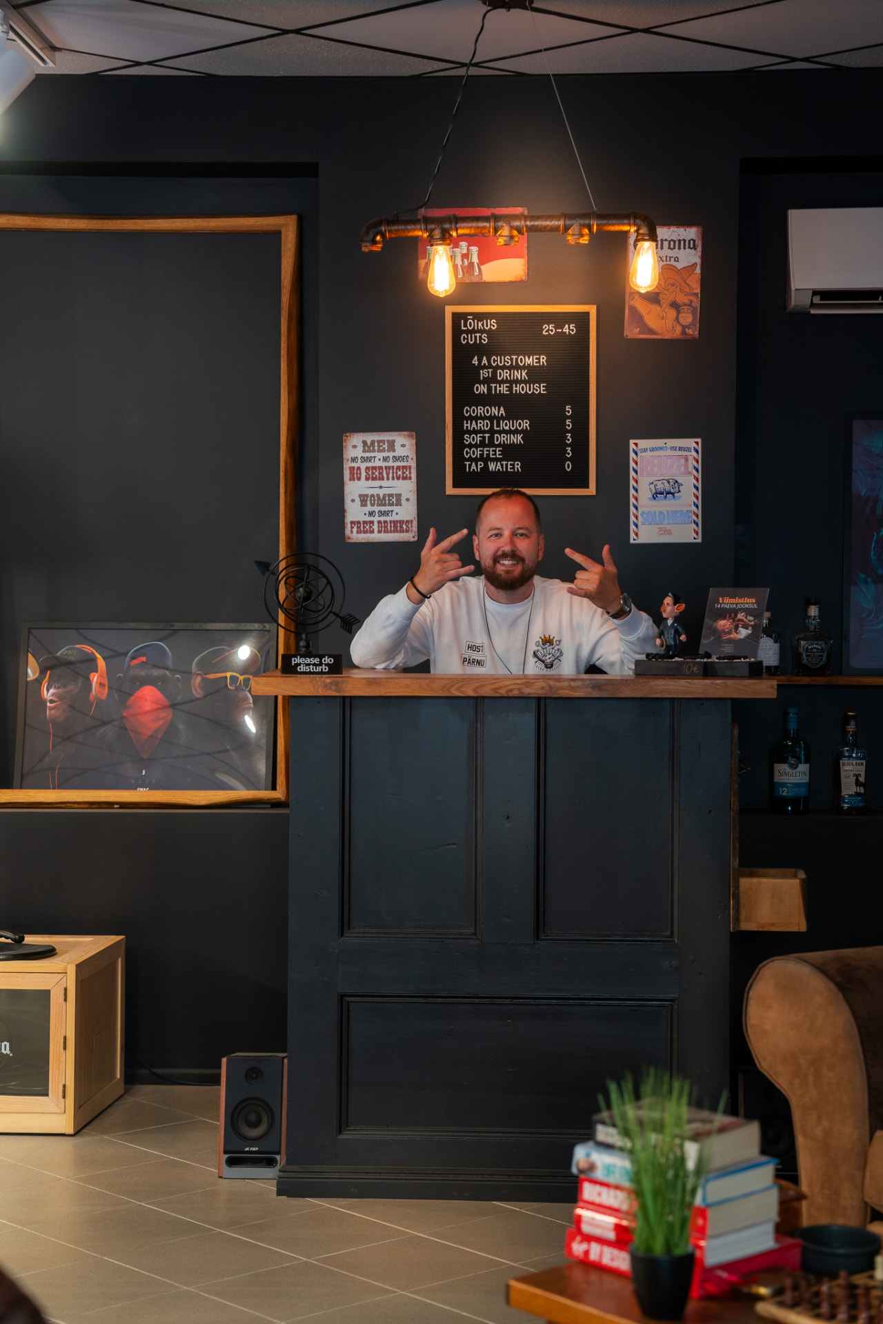 Edvin Bürkland, founder of $harp.edz, behind the counter of his barbershop